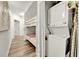 Hallway with wooden floors, a bunk bed, and a stackable washer and dryer in a closet at 13415 Blue Heron Beach Dr # 409, Orlando, FL 32821