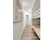 Hallway with a bunk bed, neutral paint, modern art, and wood-look flooring at 13415 Blue Heron Beach Dr # 409, Orlando, FL 32821