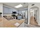 Bright kitchen with granite countertops, stainless steel appliances, and blue cabinets at 13415 Blue Heron Beach Dr # 409, Orlando, FL 32821