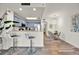 Open-concept kitchen with breakfast bar, stainless steel appliances, and a dining area with modern lighting fixtures at 13415 Blue Heron Beach Dr # 409, Orlando, FL 32821