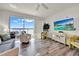 Bright, open living area with a waterfront view, modern furnishings, and a large TV at 13415 Blue Heron Beach Dr # 409, Orlando, FL 32821