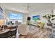 Bright living room with a waterfront view, modern furnishings, and wood-look flooring at 13415 Blue Heron Beach Dr # 409, Orlando, FL 32821