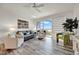Cozy living room filled with natural light, stylish seating, and access to the balcony at 13415 Blue Heron Beach Dr # 409, Orlando, FL 32821