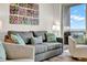 Comfortable living room area with a gray sofa, colorful pillows and unique wall art at 13415 Blue Heron Beach Dr # 409, Orlando, FL 32821