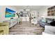 Bright living room with wood floors, modern furnishings, and an open floor plan into the kitchen and dining area at 13415 Blue Heron Beach Dr # 409, Orlando, FL 32821