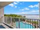 Gorgeous pool view from balcony overlooking pool, lake, and surrounding green landscaping at 13415 Blue Heron Beach Dr # 409, Orlando, FL 32821