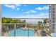Lovely views from balcony overlooking a large in-ground pool, lake, and surrounding landscaping at 13415 Blue Heron Beach Dr # 409, Orlando, FL 32821
