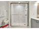 Updated bathroom featuring a glass-enclosed shower, marble-look tile, and modern fixtures at 13415 Blue Heron Beach Dr # 409, Orlando, FL 32821
