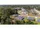 An aerial view showcases the home's location within a serene, wooded neighborhood at 13621 Sw 40Th Cir, Ocala, FL 34473