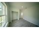 Light-filled bedroom features a spacious closet and modern gray wood-look flooring at 13621 Sw 40Th Cir, Ocala, FL 34473