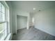 Well-lit bedroom boasts a closet, recessed lighting, and chic gray wood-look floors at 13621 Sw 40Th Cir, Ocala, FL 34473