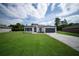 Charming single-Gathering home featuring a well manicured lawn, modern design, and a paved driveway at 13621 Sw 40Th Cir, Ocala, FL 34473