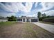 Charming single-Gathering home featuring a lawn, modern design, and a paved driveway at 13621 Sw 40Th Cir, Ocala, FL 34473