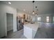 Spacious modern kitchen featuring an island, pantry, stainless steel appliances, and open floor plan at 13621 Sw 40Th Cir, Ocala, FL 34473