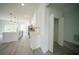Bright, modern kitchen area with a view of the open floor plan, featuring stylish white cabinets at 13621 Sw 40Th Cir, Ocala, FL 34473