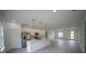 Open-concept living space with a modern kitchen island and stainless steel appliances, great for entertaining guests at 13621 Sw 40Th Cir, Ocala, FL 34473