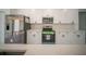 Modern kitchen features stainless steel appliances, sleek white cabinetry, and ample quartz countertop space at 13621 Sw 40Th Cir, Ocala, FL 34473