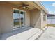 Open back patio featuring a ceiling fan and view of well maintained backyard at 140 Highland Meadows St, Davenport, FL 33837