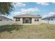 Spacious backyard with well-maintained lawn, white fence, and covered patio at 140 Highland Meadows St, Davenport, FL 33837