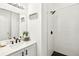 Well-lit bathroom with modern sink, vanity, and walk-in shower with black hardware at 140 Highland Meadows St, Davenport, FL 33837