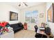 Well-lit bedroom featuring a large window, wood-look floors, and ample space for a futon and desk at 140 Highland Meadows St, Davenport, FL 33837
