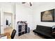 Comfortable bedroom with a black futon, a storage cubby, and a decorative art piece on the wall at 140 Highland Meadows St, Davenport, FL 33837