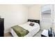Cozy bedroom with a large window, wood-look flooring, and neutral decor at 140 Highland Meadows St, Davenport, FL 33837