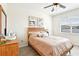 A serene bedroom with hardwood floors, ceiling fan, and natural light from the window at 140 Highland Meadows St, Davenport, FL 33837