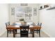 Dining room featuring a wooden table, black chairs, and natural light from the window at 140 Highland Meadows St, Davenport, FL 33837