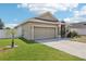 Attractive single-story home with a neat lawn, concrete driveway, and attached two-car garage at 140 Highland Meadows St, Davenport, FL 33837