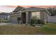 Single Gathering home has manicured front yard, attached garage, and neutral color palette at 140 Highland Meadows St, Davenport, FL 33837