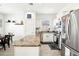 Bright kitchen featuring stainless steel appliances, granite countertops, and white cabinetry at 140 Highland Meadows St, Davenport, FL 33837