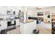 A modern kitchen with stainless steel appliances that opens to the cozy living room at 140 Highland Meadows St, Davenport, FL 33837