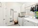 Functional laundry room with modern washer, dryer, storage, and stylish decor at 140 Highland Meadows St, Davenport, FL 33837