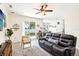 Open-concept living area with modern decor, ample natural light, and sliding glass doors to the backyard at 140 Highland Meadows St, Davenport, FL 33837