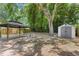 Spacious backyard featuring a gazebo, storage shed, and lush greenery at 141 S Lawsona Blvd, Orlando, FL 32801