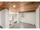 Basement featuring built-in shelves, a wood ceiling, updated windows, and an unfinished floor at 141 S Lawsona Blvd, Orlando, FL 32801