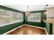 Green dining room with hardwood floors and lots of natural light at 141 S Lawsona Blvd, Orlando, FL 32801