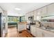 Modern kitchen featuring stainless appliances, stone counters, and stylish white cabinetry at 141 S Lawsona Blvd, Orlando, FL 32801
