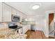 Modern kitchen with stainless appliances, stone counters, and stylish white cabinetry at 141 S Lawsona Blvd, Orlando, FL 32801