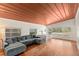 Bright living room boasts hardwood floors, a sectional couch, and lots of natural light at 141 S Lawsona Blvd, Orlando, FL 32801