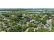 Aerial view of a lush neighborhood with tree-lined streets and scenic water views at 141 S Phelps Ave, Winter Park, FL 32789