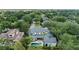 An aerial view of a large home featuring a pool, patio, and lush landscaping at 141 S Phelps Ave, Winter Park, FL 32789