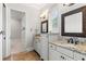 Well-lit bathroom featuring granite countertops and white cabinets offering ample storage space at 141 S Phelps Ave, Winter Park, FL 32789