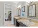 Bathroom includes dual sinks, updated vanities, decorative mirrors, and a view to the bedroom at 141 S Phelps Ave, Winter Park, FL 32789