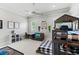 Bright bedroom features a ceiling fan, bunk beds, and cozy sitting area at 141 S Phelps Ave, Winter Park, FL 32789