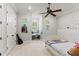 Bright bedroom with a ceiling fan and charming decor with lots of natural light from multiple windows at 141 S Phelps Ave, Winter Park, FL 32789