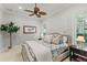 This bedroom features a ceiling fan, neutral colors, and plantation shutters at 141 S Phelps Ave, Winter Park, FL 32789
