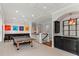 Large bonus room features a ping pong table, bar area, and access to the second floor at 141 S Phelps Ave, Winter Park, FL 32789