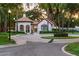 Elegant community entrance featuring a charming white structure with red tile roof at 141 S Phelps Ave, Winter Park, FL 32789